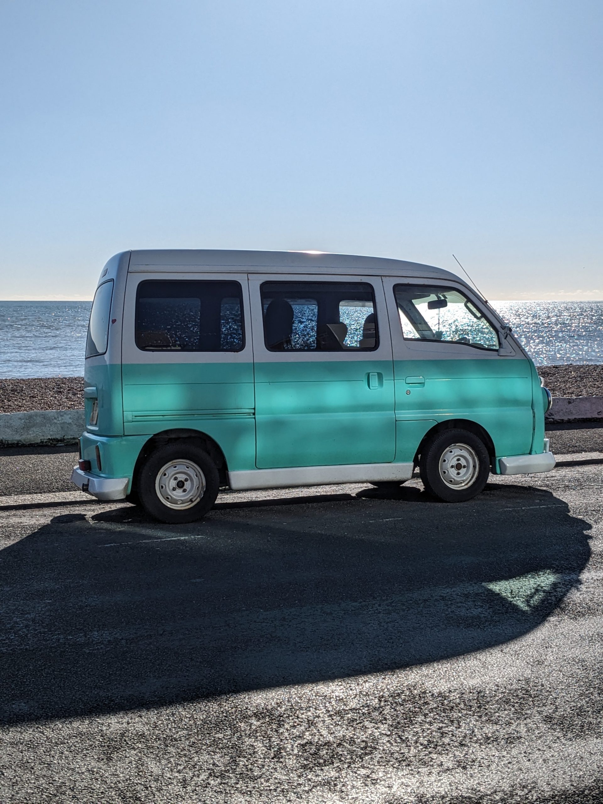 Wedding car hire. Wedding Campervan at venue, it's a Susuki campervan in mint green and white.